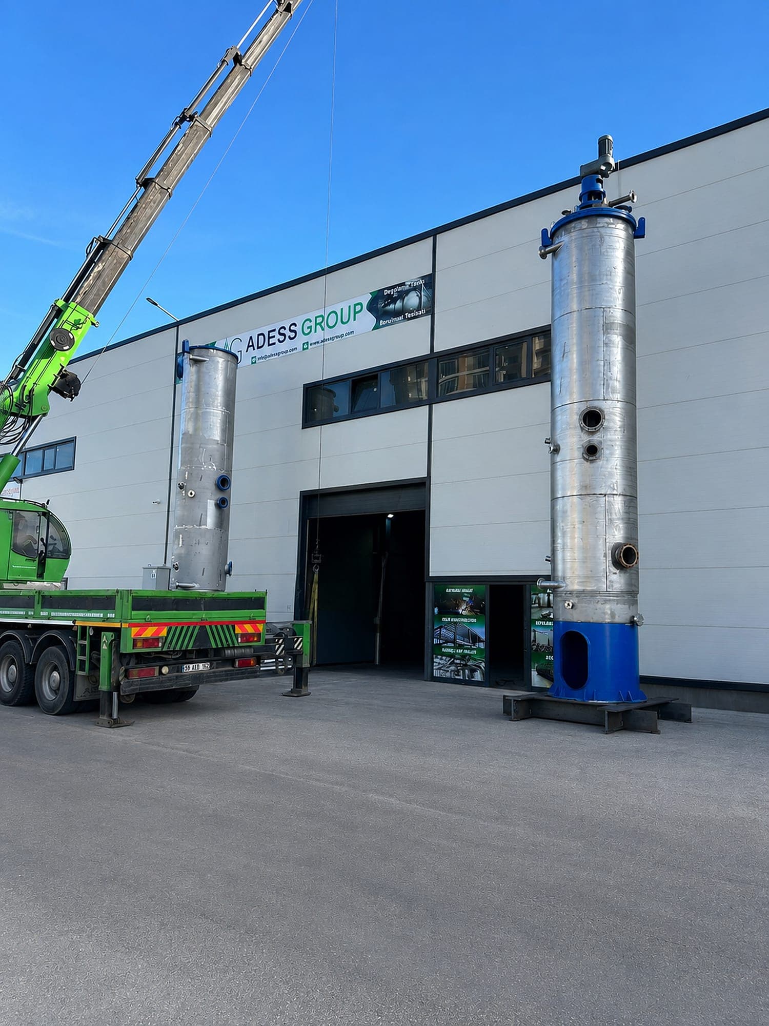 Finished stainless steel process columns on support bases ready for dispatch